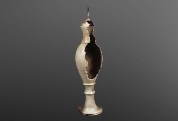 Beige vase, made of curved lines and ending in a sharp point. Parts of the glaze have been blackened. 